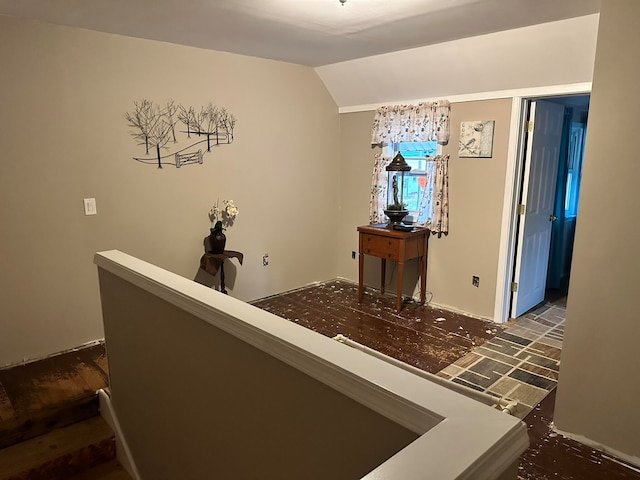 hall with vaulted ceiling and dark hardwood / wood-style flooring