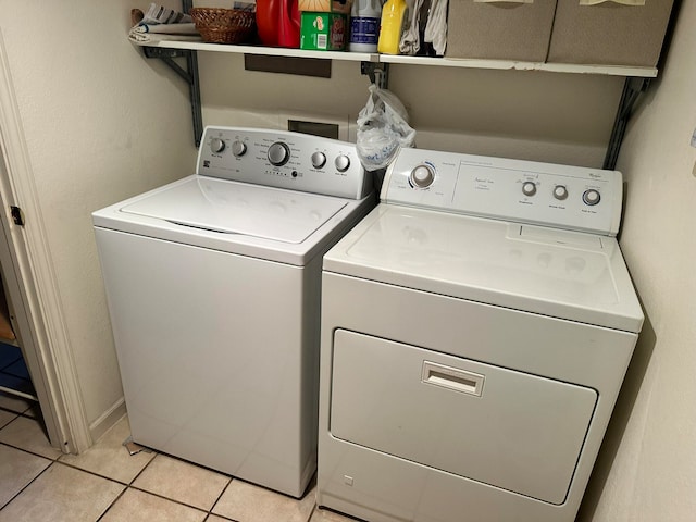 laundry room with separate washer and dryer and light tile patterned floors