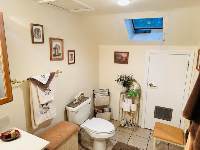 bathroom with toilet, lofted ceiling, heating unit, and tile patterned flooring