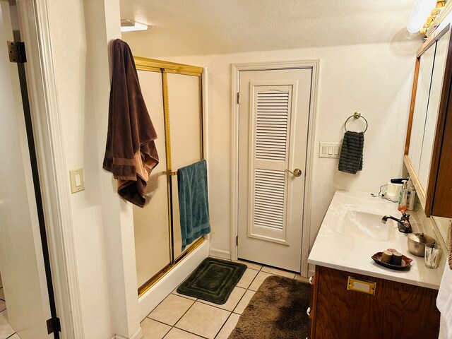 bathroom with vanity, tile patterned flooring, and an enclosed shower