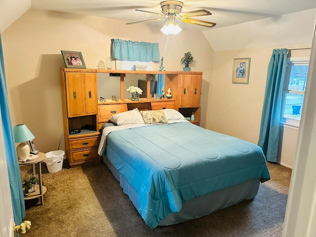 bedroom featuring dark carpet, lofted ceiling, and ceiling fan