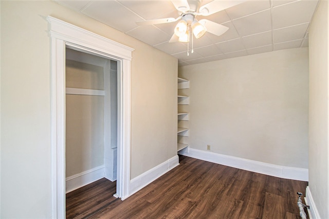 unfurnished bedroom featuring dark hardwood / wood-style floors, a closet, and ceiling fan