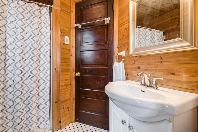 bathroom with vanity and wooden walls