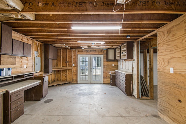 basement featuring french doors and electric panel