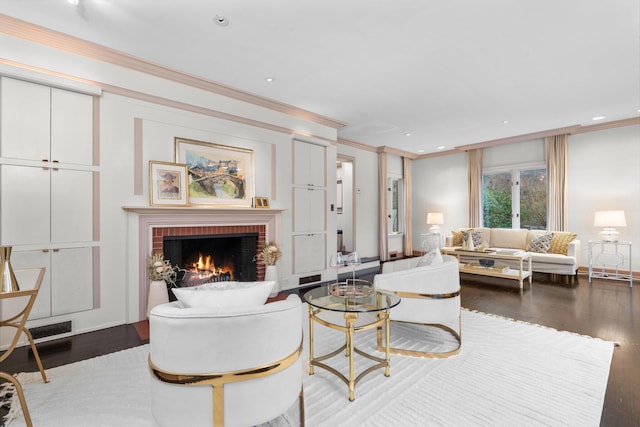 living room featuring crown molding, wood-type flooring, and a brick fireplace