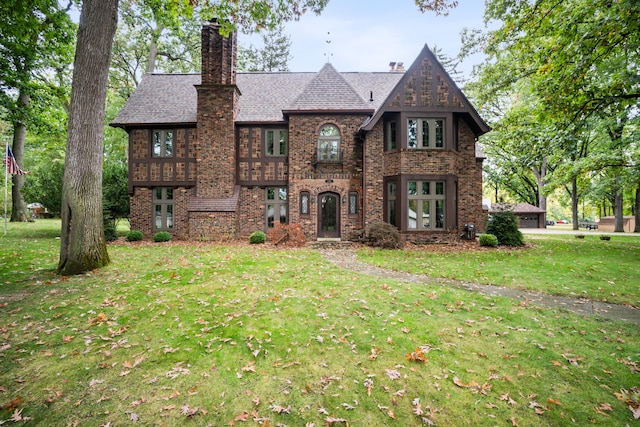 tudor house featuring a front lawn