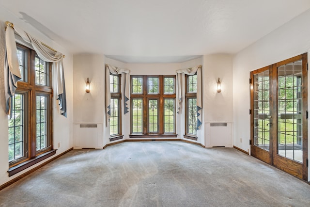 empty room featuring carpet and radiator