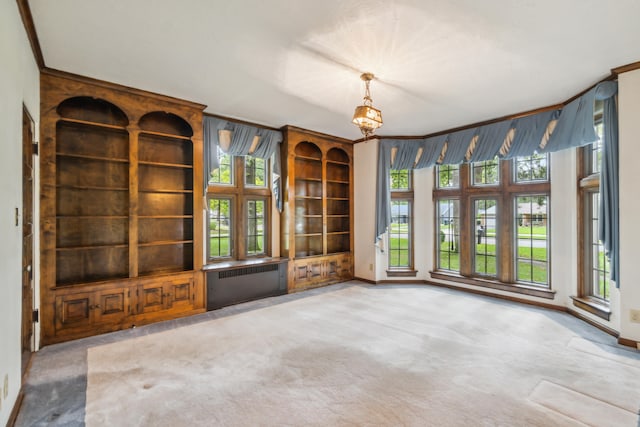 unfurnished living room featuring crown molding, light colored carpet, and radiator