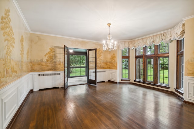 unfurnished room with dark hardwood / wood-style flooring, ornamental molding, a chandelier, and radiator