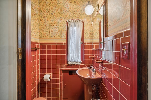 bathroom with tile walls