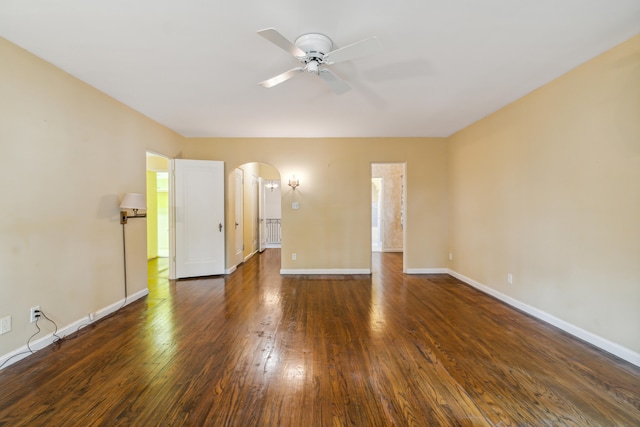 empty room with ceiling fan and dark hardwood / wood-style flooring