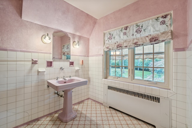 bathroom with radiator heating unit and tile walls