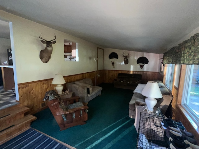 carpeted living room with wooden walls