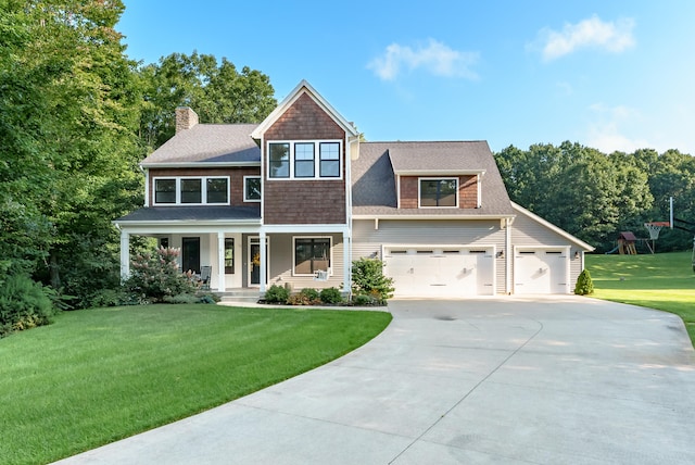 view of front of house featuring a porch, a front lawn, and a garage