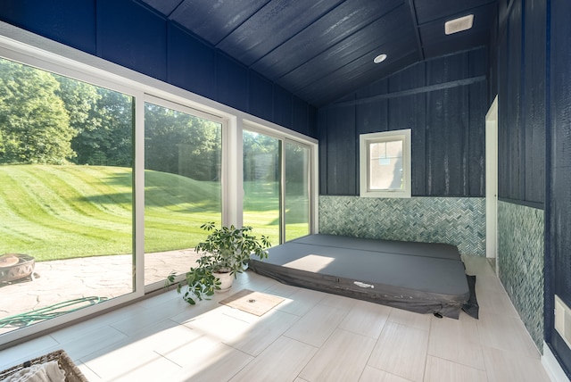 unfurnished sunroom featuring lofted ceiling