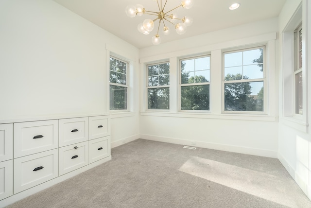 unfurnished sunroom featuring a chandelier