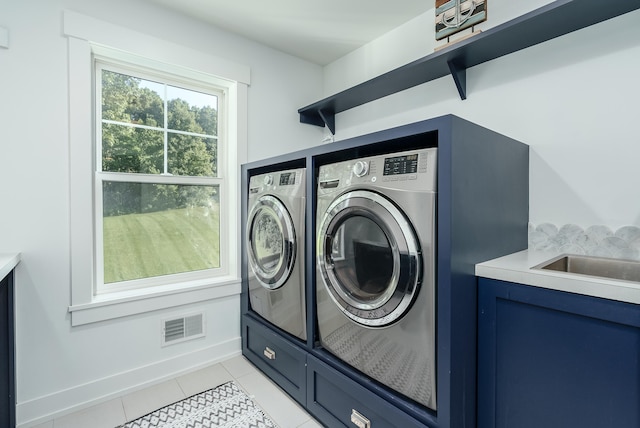 washroom featuring washer and dryer and light tile patterned floors