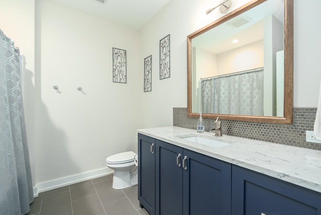 bathroom featuring vanity, decorative backsplash, toilet, and tile patterned flooring