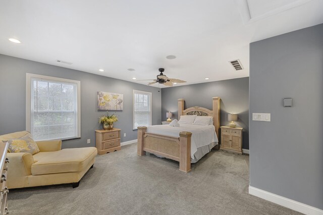 carpeted bedroom with multiple windows and ceiling fan