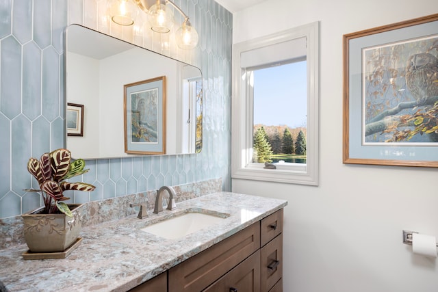 bathroom featuring vanity and decorative backsplash