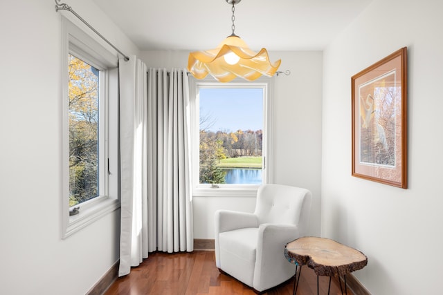 sitting room featuring dark hardwood / wood-style flooring and a chandelier