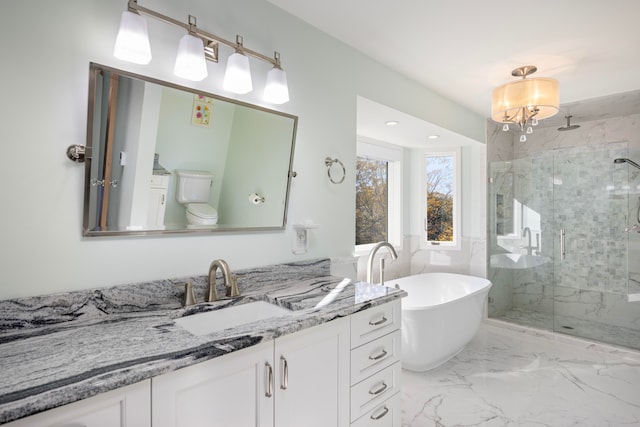 full bathroom featuring vanity, shower with separate bathtub, and toilet