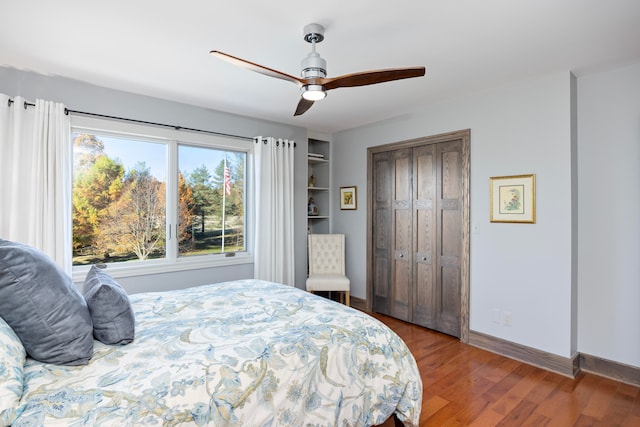 bedroom featuring hardwood / wood-style floors, a closet, and ceiling fan