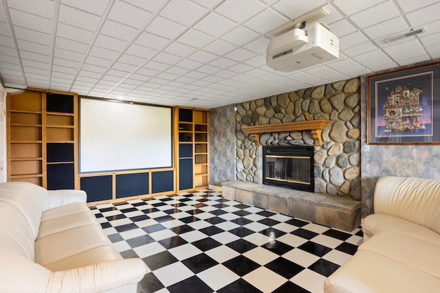 unfurnished living room with a drop ceiling and a fireplace