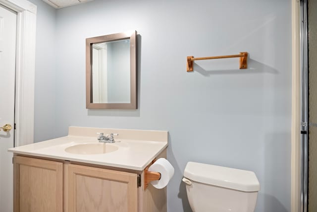 bathroom featuring toilet and vanity