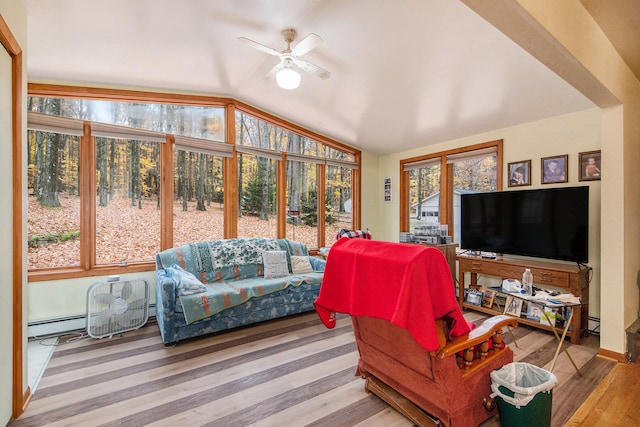 living room featuring light hardwood / wood-style floors, a healthy amount of sunlight, vaulted ceiling, and ceiling fan