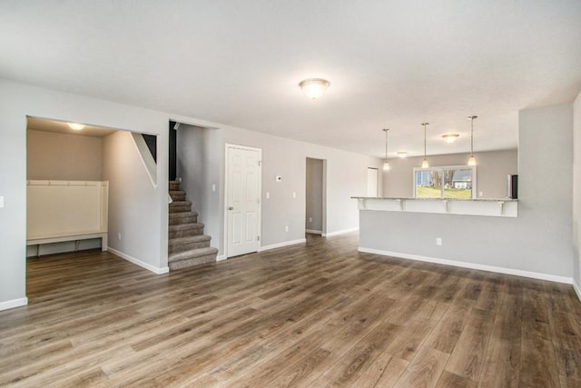 unfurnished living room with dark hardwood / wood-style floors