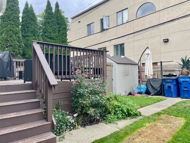 exterior space featuring a storage unit and a deck