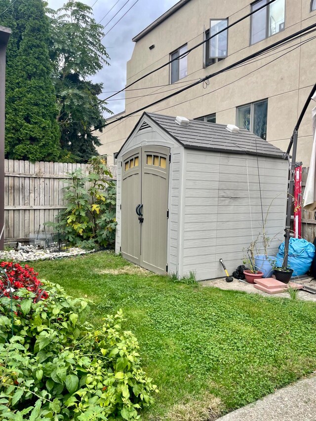 view of outdoor structure featuring a lawn