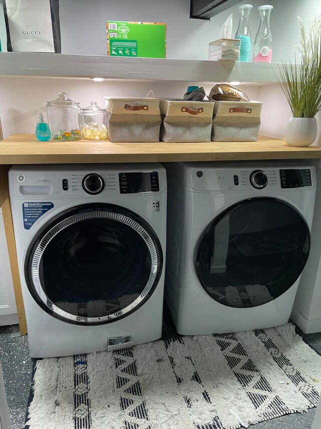 clothes washing area with washer and dryer