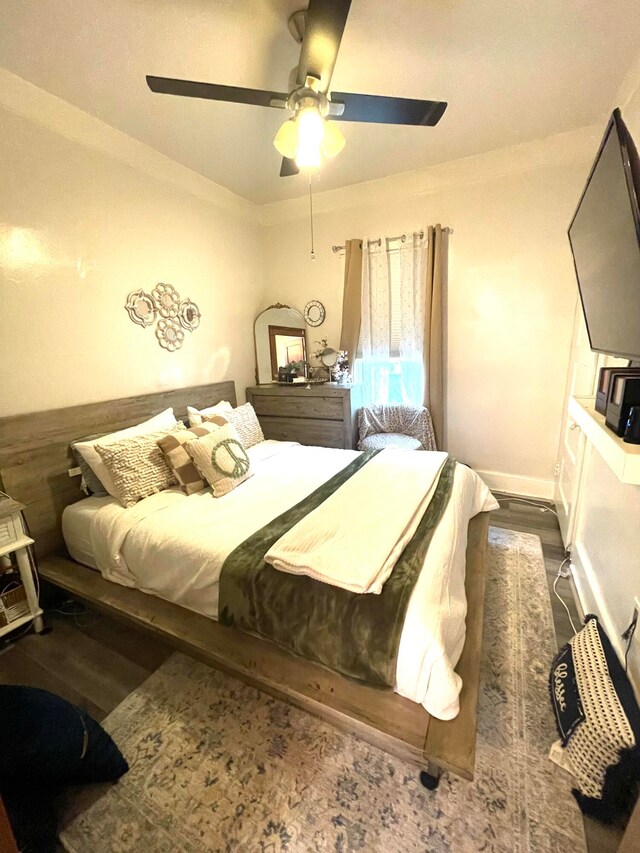 bedroom featuring dark hardwood / wood-style flooring and ceiling fan