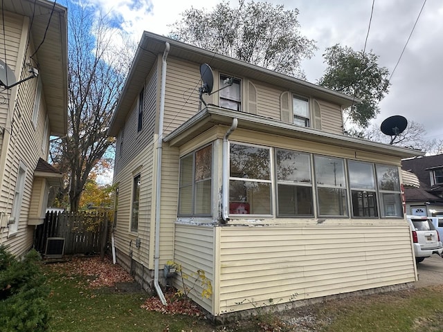 view of side of home featuring a sunroom