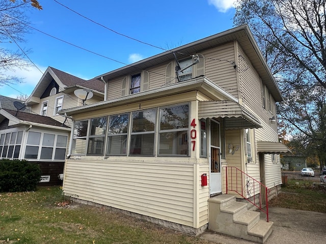 view of front of home with a sunroom