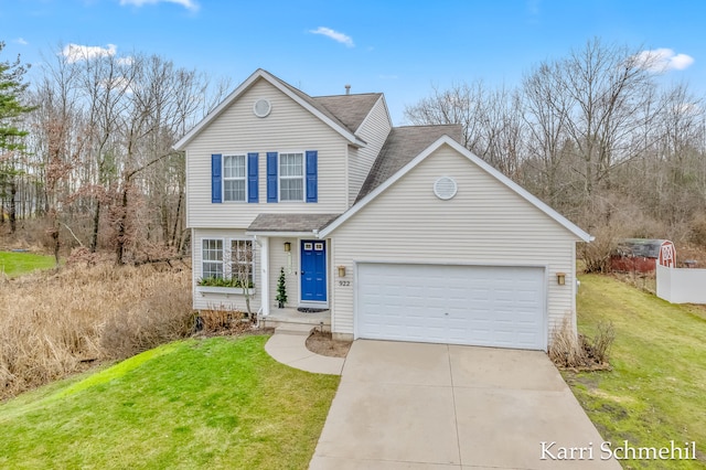 view of front property featuring a garage and a front lawn