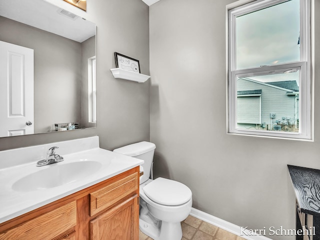 bathroom featuring vanity and toilet