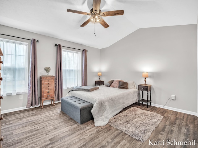 bedroom with ceiling fan, vaulted ceiling, and hardwood / wood-style flooring