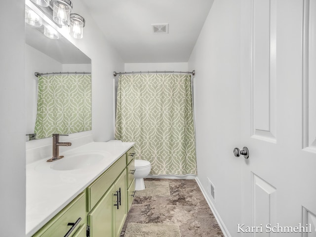 bathroom featuring vanity, curtained shower, and toilet