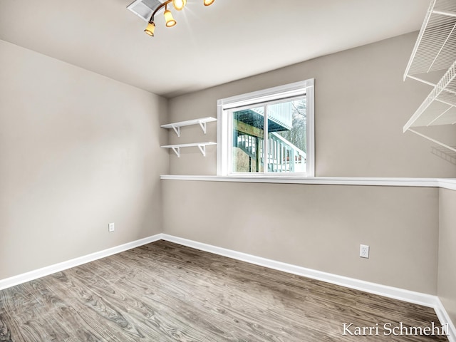 spare room with wood-type flooring