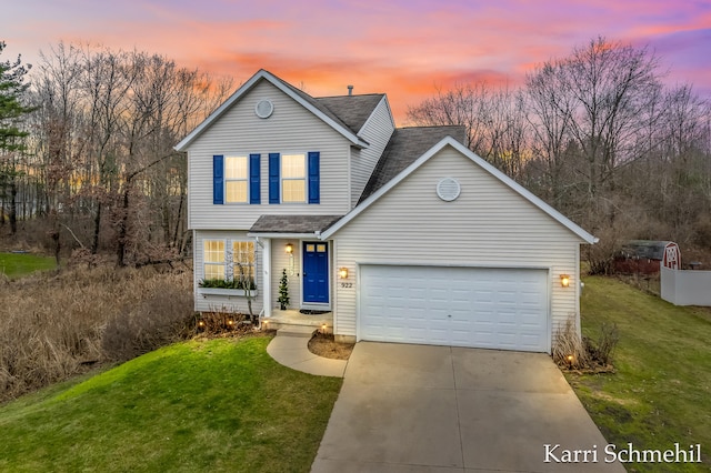 view of property with a lawn and a garage