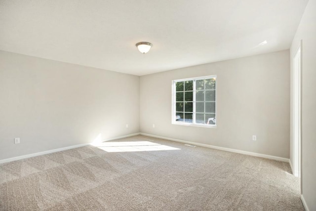 empty room featuring light colored carpet