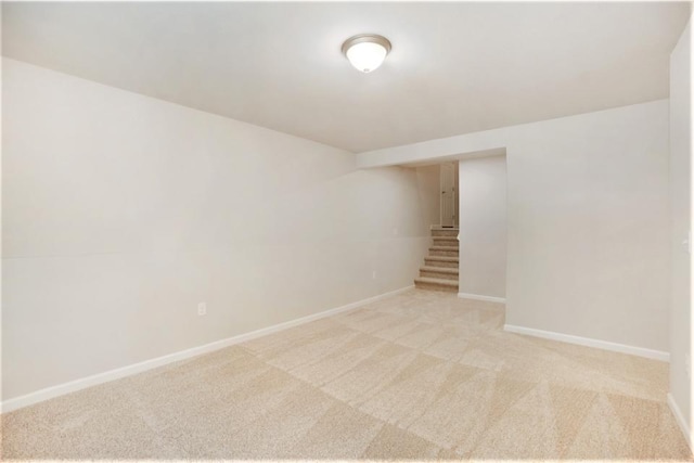 basement featuring light colored carpet