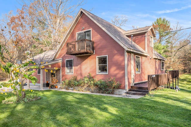 rear view of house featuring a patio and a lawn