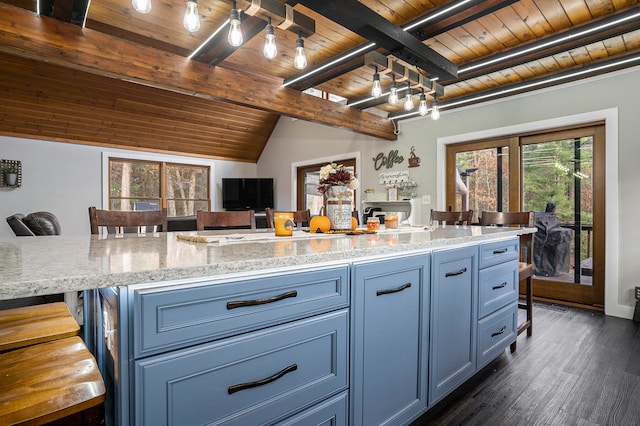 kitchen featuring a kitchen island, lofted ceiling with beams, dark hardwood / wood-style flooring, a kitchen breakfast bar, and wooden ceiling