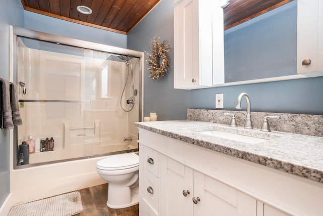 full bathroom with wood ceiling, toilet, wood-type flooring, bath / shower combo with glass door, and vanity