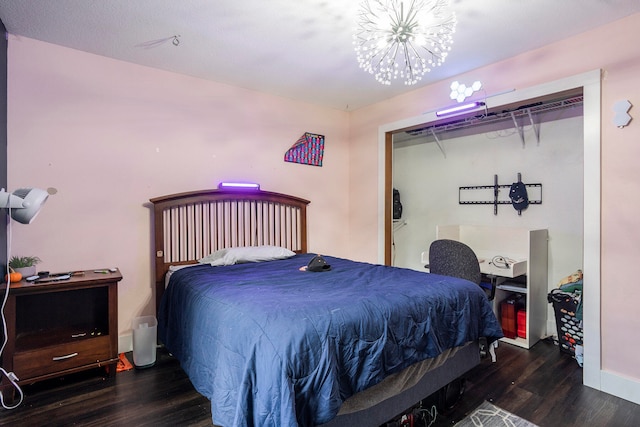 bedroom with a chandelier and dark hardwood / wood-style floors