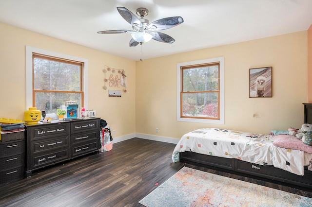 bedroom with dark hardwood / wood-style floors and ceiling fan